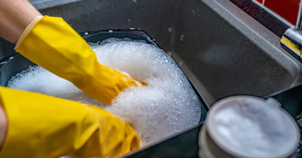 Fridge shelves soaking in hot soapy water for deep clean
