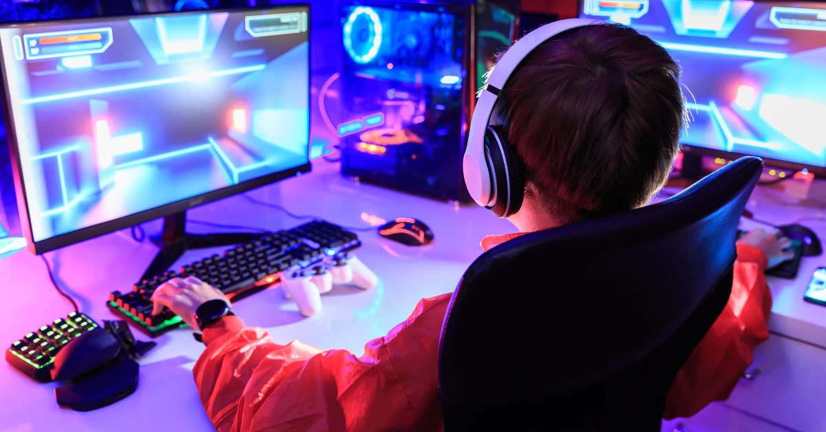 Gamer playing on a gaming monitor setup with purple lighting