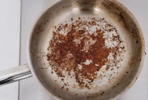 Burnt food residue stuck on the inside of a stainless steel pan