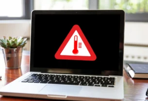 Laptop screen showing a red warning sign