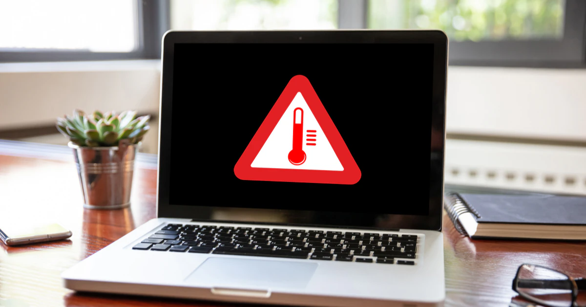 Laptop screen showing a red warning sign
