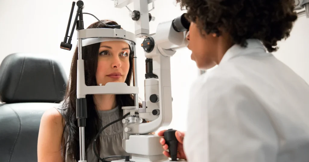Doctor examining a woman's eyes with an eye exam machine