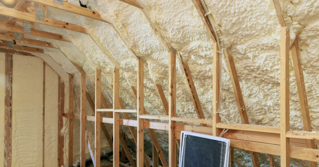 Attic with wooden beams and insulation where rats often nest