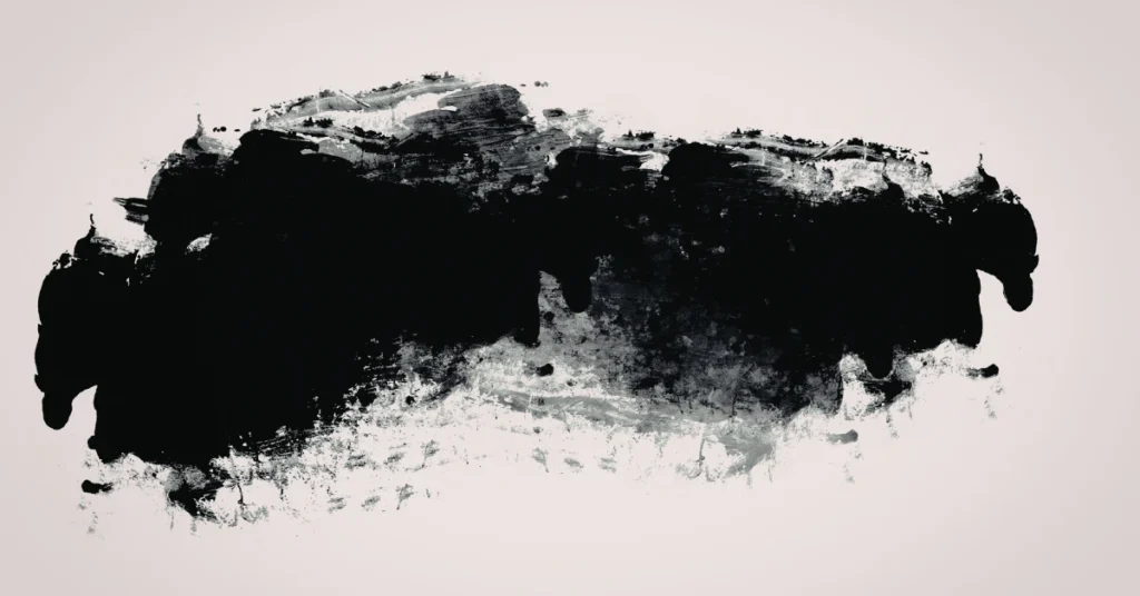 Black ink-like grease splatter on a plain background, representing a stubborn oil stain