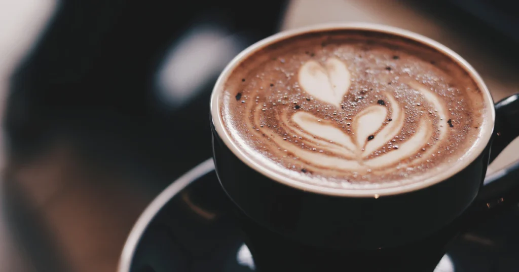 Cup of latte with heart-shaped foam art