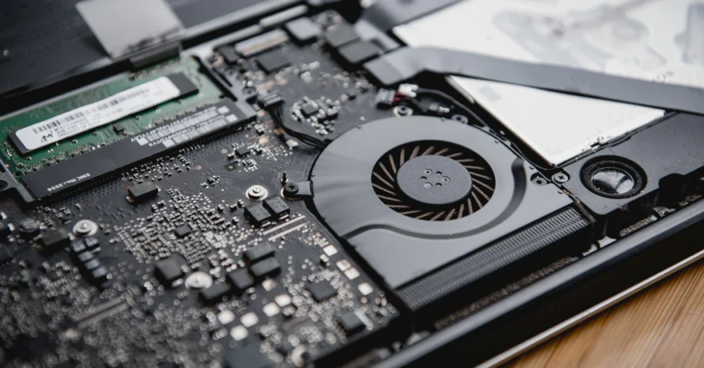 Inside of an open laptop showing the cooling fan and internal components
